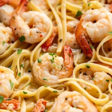 Close up view of shrimp scampi in a large skillet.