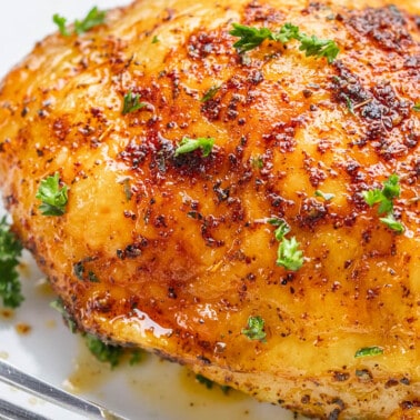 Close up view of a chicken thigh cooked in an air fryer.