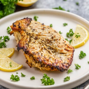 Air fried chicken breast on a dinner plate.