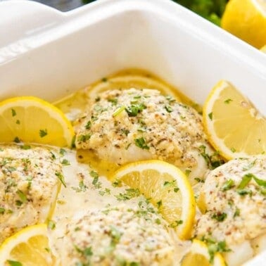 Close up of lemon baked codfish in a baking pan.