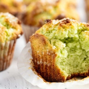 Close up of Pistachio Muffins one with a big bite out of it