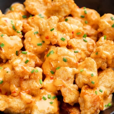 Overhead view looking into a black serving bowl with bang bang chicken.