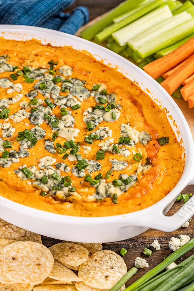 Buffalo chicken dip with green onions on top.