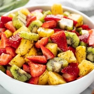 Angled view of Summer Fruit Salad in a white bowl.