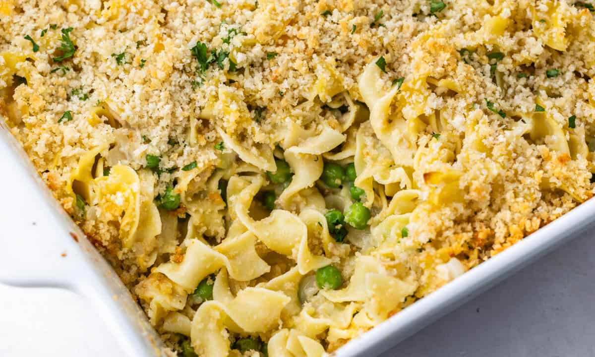 Close up view of tuna casserole in a white baking dish.