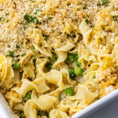 Close up view of tuna casserole in a white baking dish.