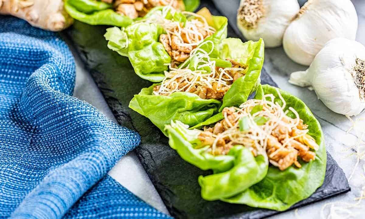 Chicken lettuce wraps in a row.