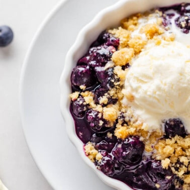 Overhead view of a blueberry crumble in a small dish.