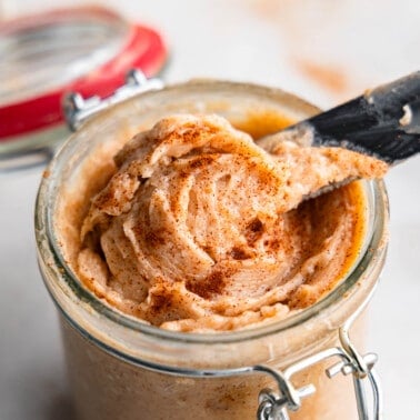 A close up view of a knife dishing out cinnamon butter.