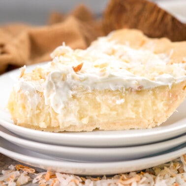 Close up view of a slice of coconut cream pie.