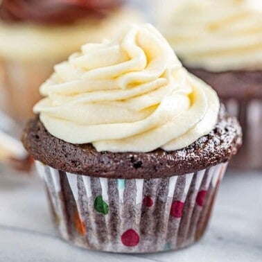 sweetened condensed milk frosting on a chocolate cupcake