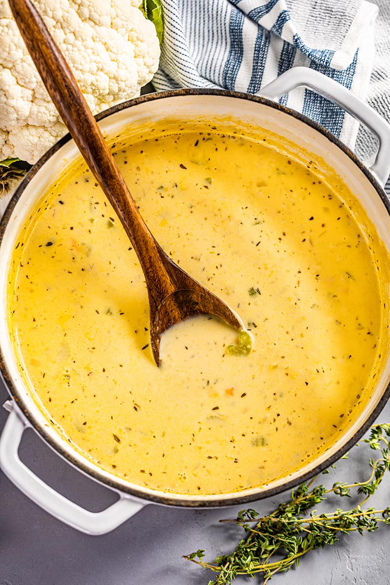 Overhead view of a large pot filled with creamy cauliflower soup.