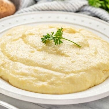 a bowl of creamy cheddar parmesan polenta