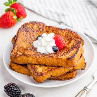 Crème brûlée french toast stacked on a white plate.