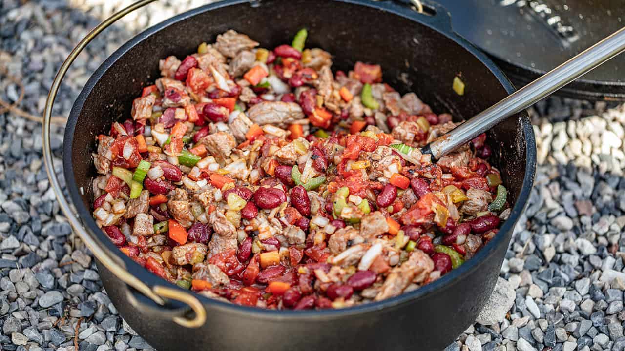 Chili in cast iron dutch oven on charcoal