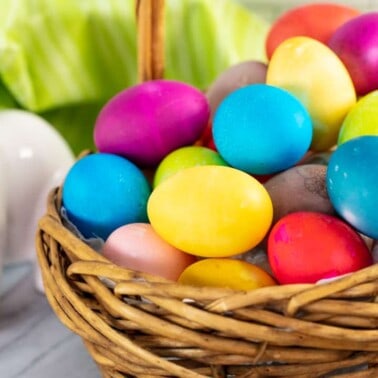 A basket full of dyed eggs.