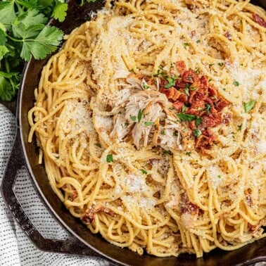 Overhead view of chicken carbonara in a skillet.