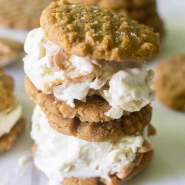 Calling all peanut butter lovers! These easy peanut butter cookie ice cream sandwiches are made with flourless peanut butter cookies and homemade peanut butter swirl ice cream. This is the ultimate summer dessert!