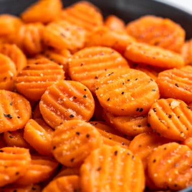 Cooked, sliced carrots in a serving bowl.