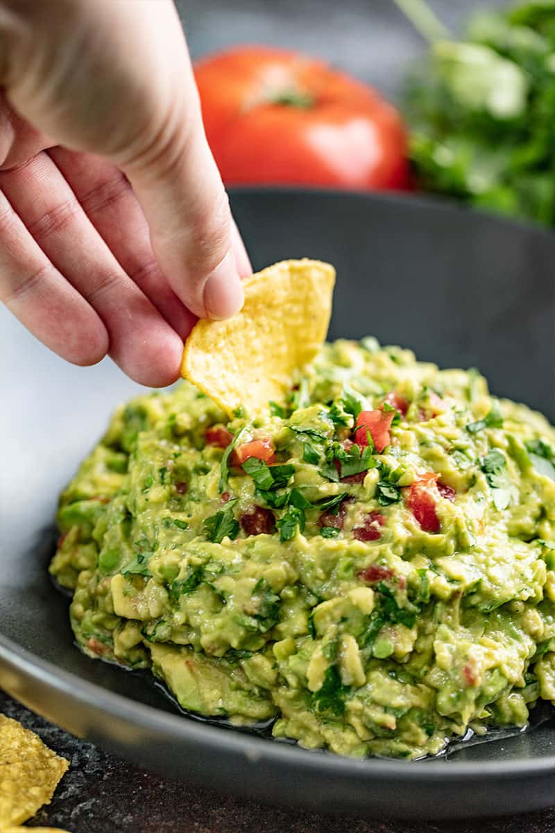 Chip being dipped in Guacamole.