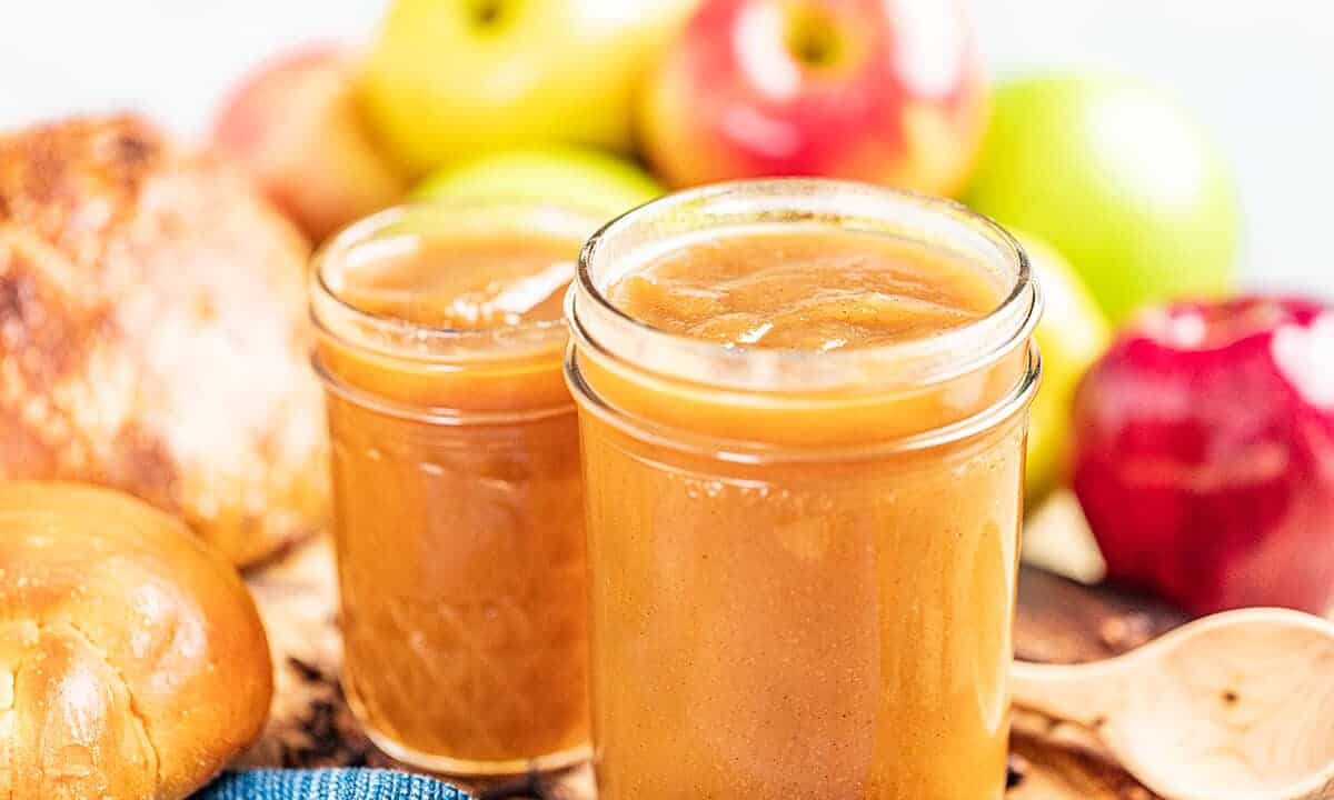 2 glass jars filled with homemade apple butter.