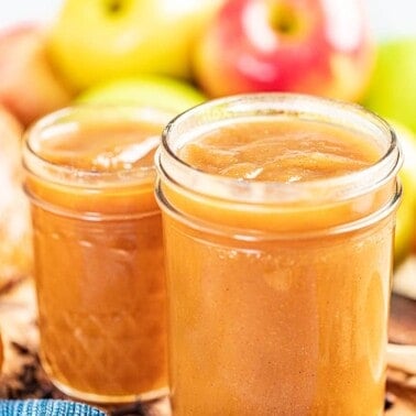 2 glass jars filled with homemade apple butter.