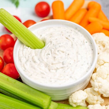 Homemade ranch dip in a bowl with a celery stick.