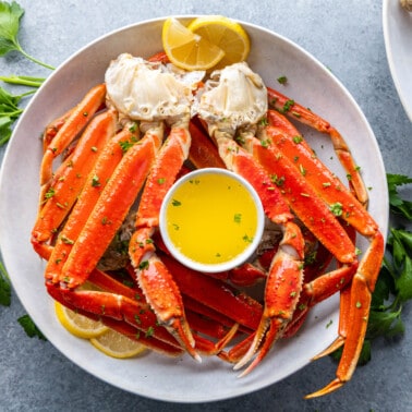 Overhead view of crab legs on a serving plate.