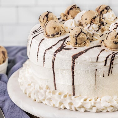 A whole decorated ice cream cake on a platter.