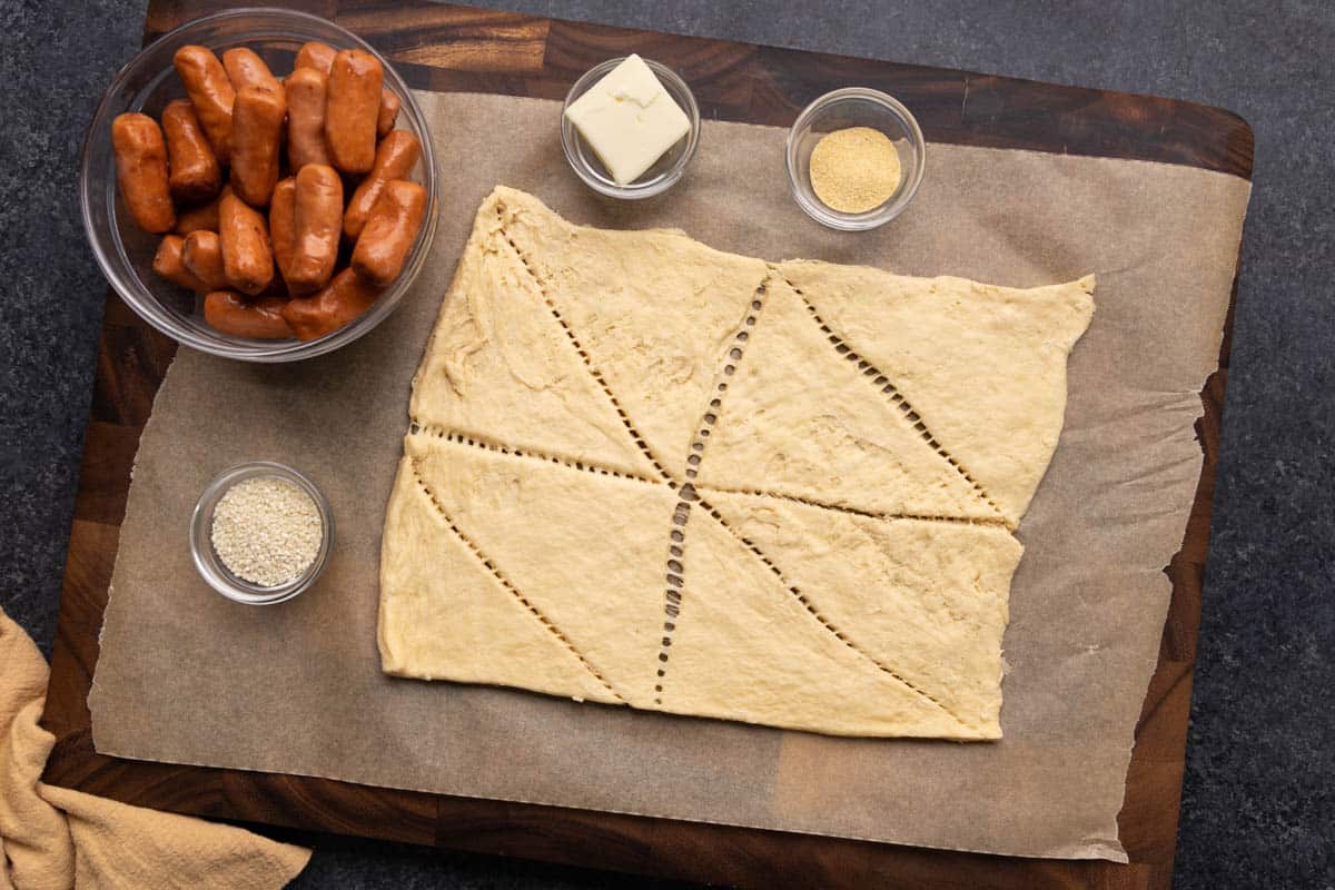 Raw ingredients laid out on a kitchen counter to make pigs in a blanket.