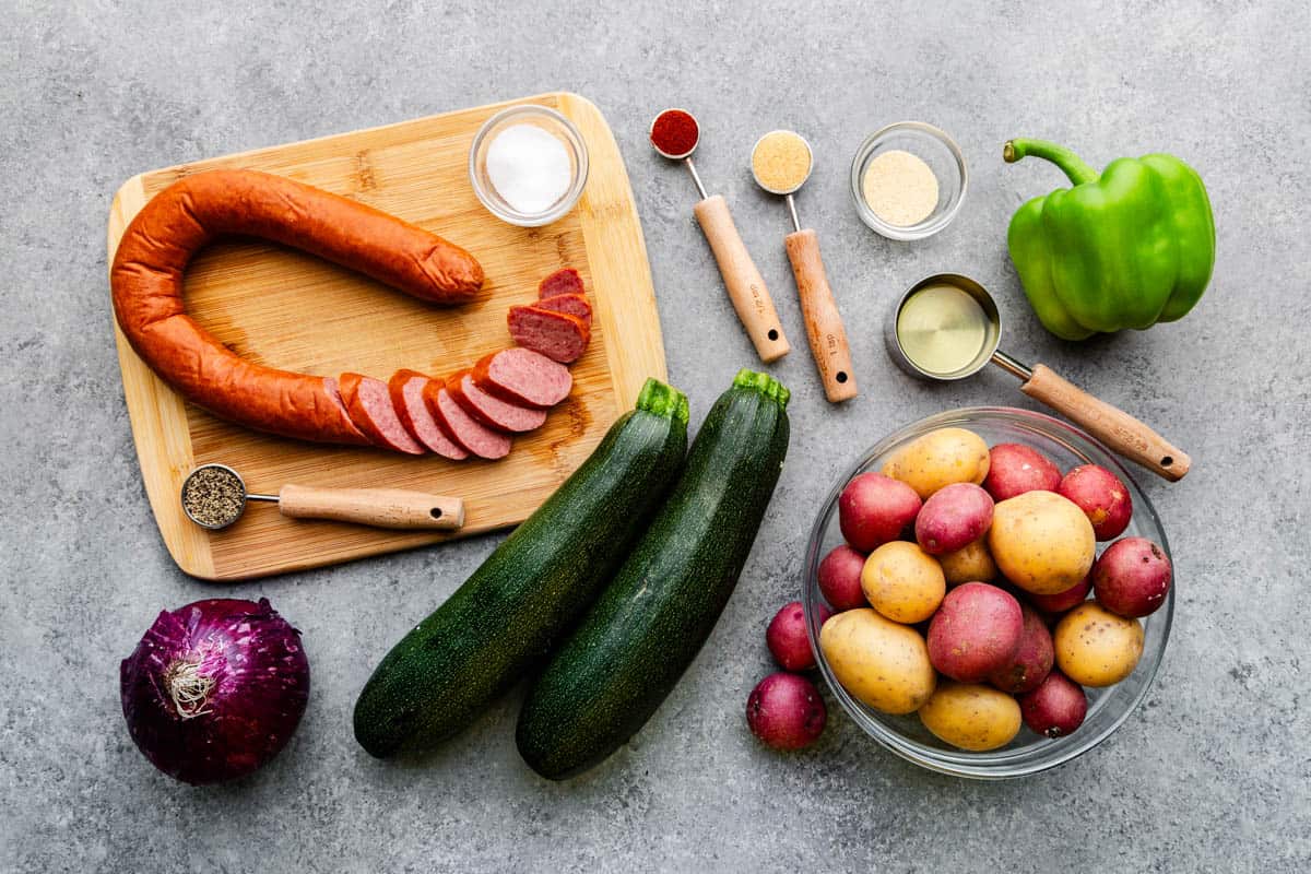 An overhead view of ingredients needed to make sheet pan sausage and veggies.