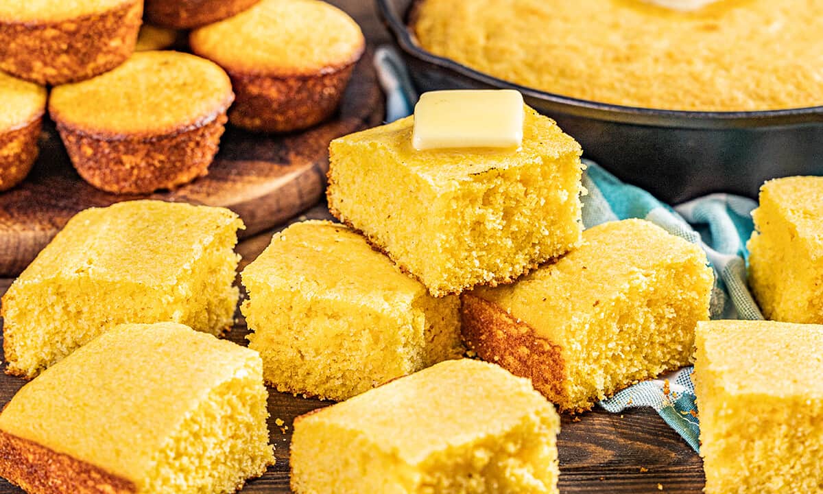 Slices of buttermilk cornbread on a wooden platter.