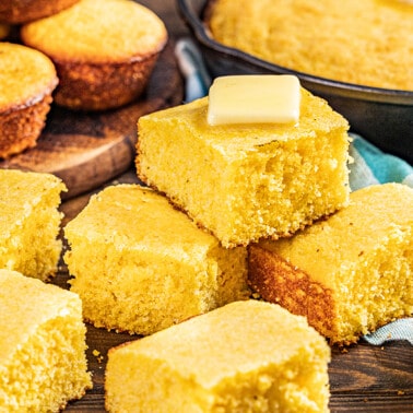 Slices of buttermilk cornbread on a wooden platter.