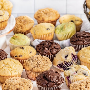 A lot of muffins all over a countertop.