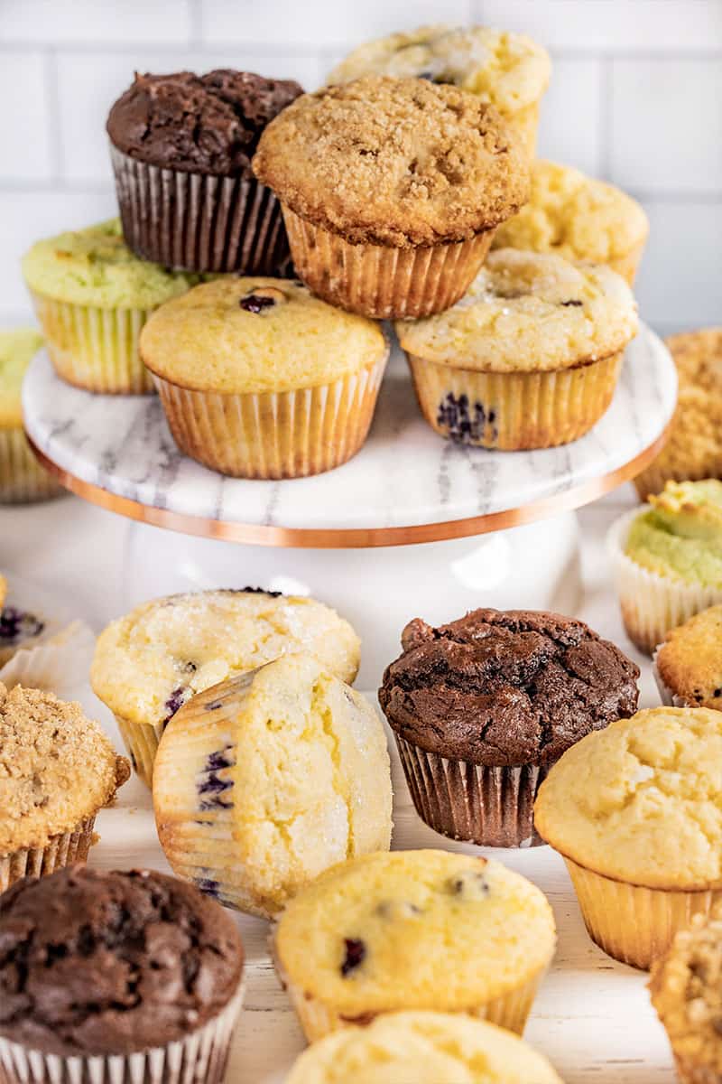 A stack of muffins on a cake stand.