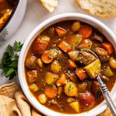 Overhead view of beef stew in a white bowl.