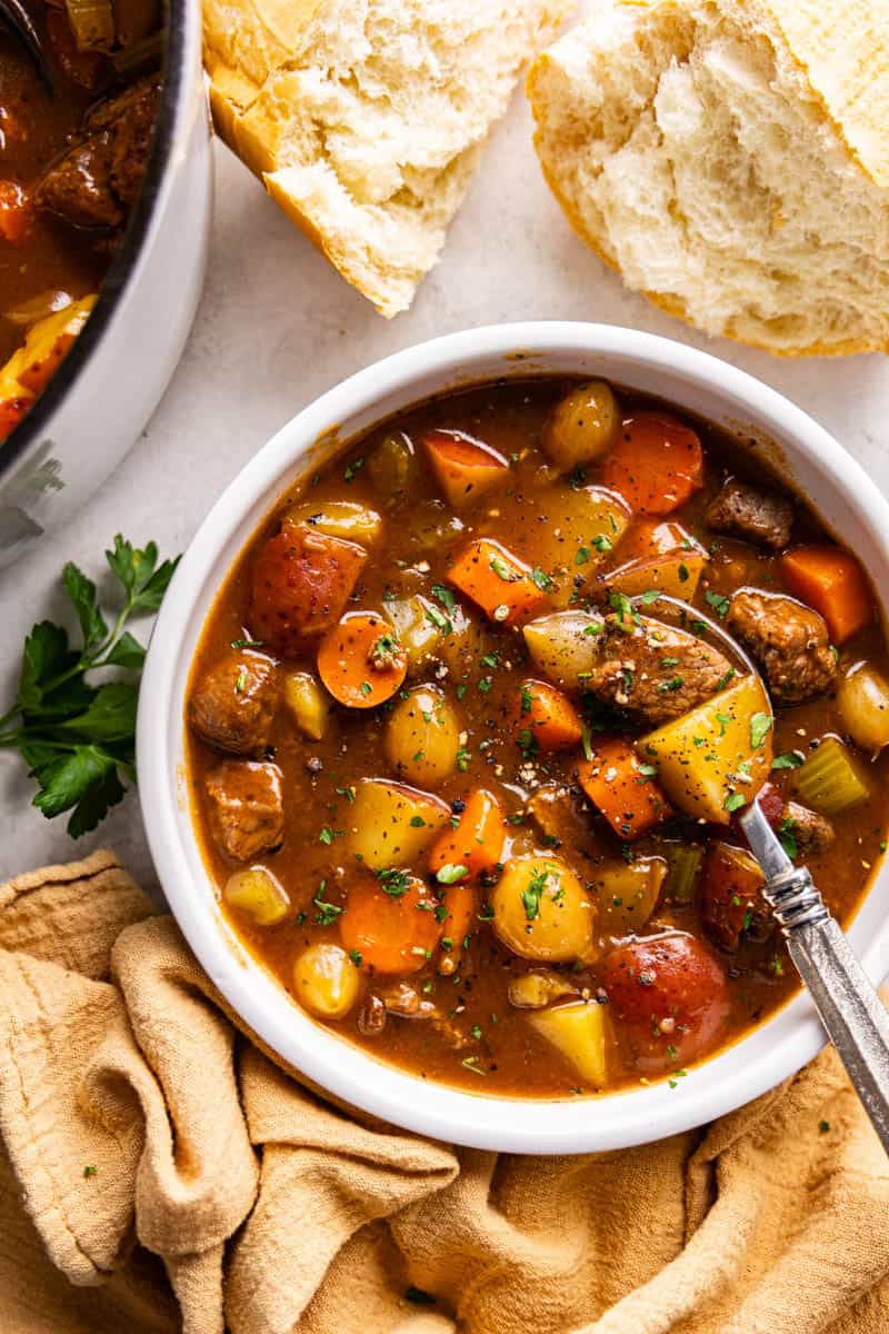 Overhead view of beef stew in a white bowl.