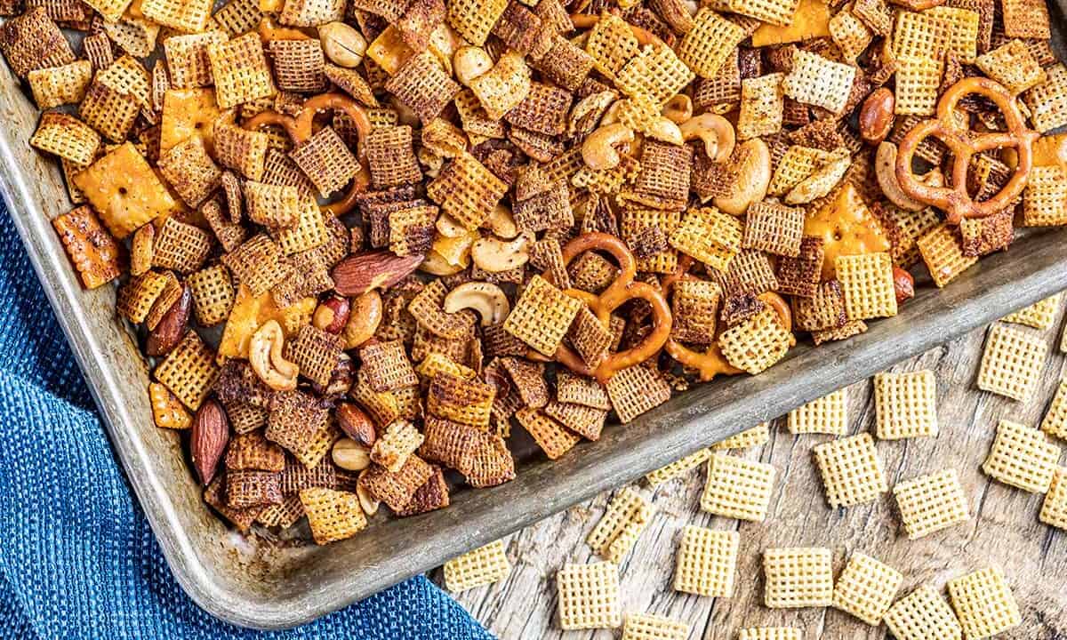 Overhead view of party Chex mix on a baking sheet.