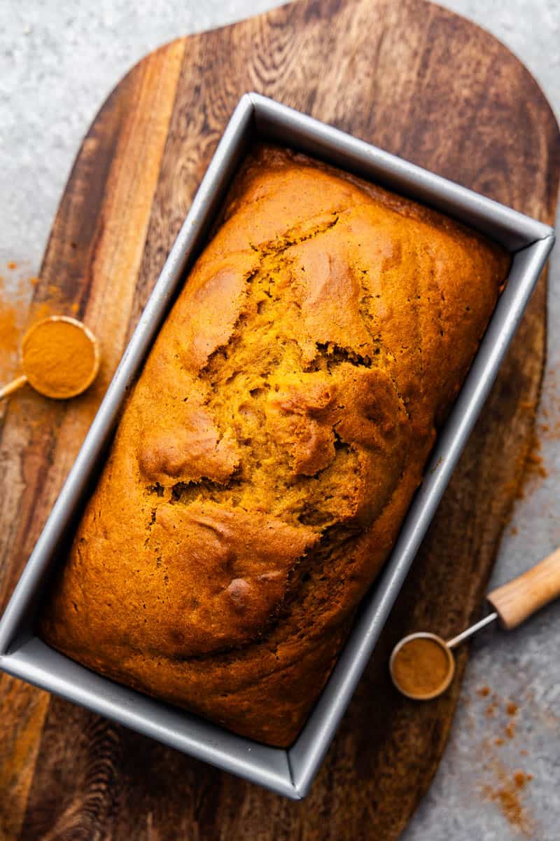 An overhead view of a loaf of pumpkin bread still in the pan.