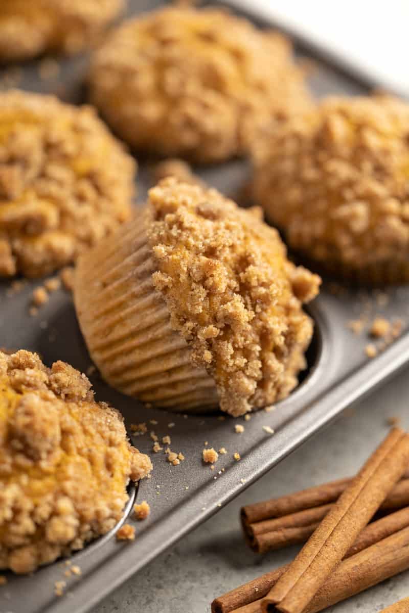 Muffin tin filled with pumpkin muffins.