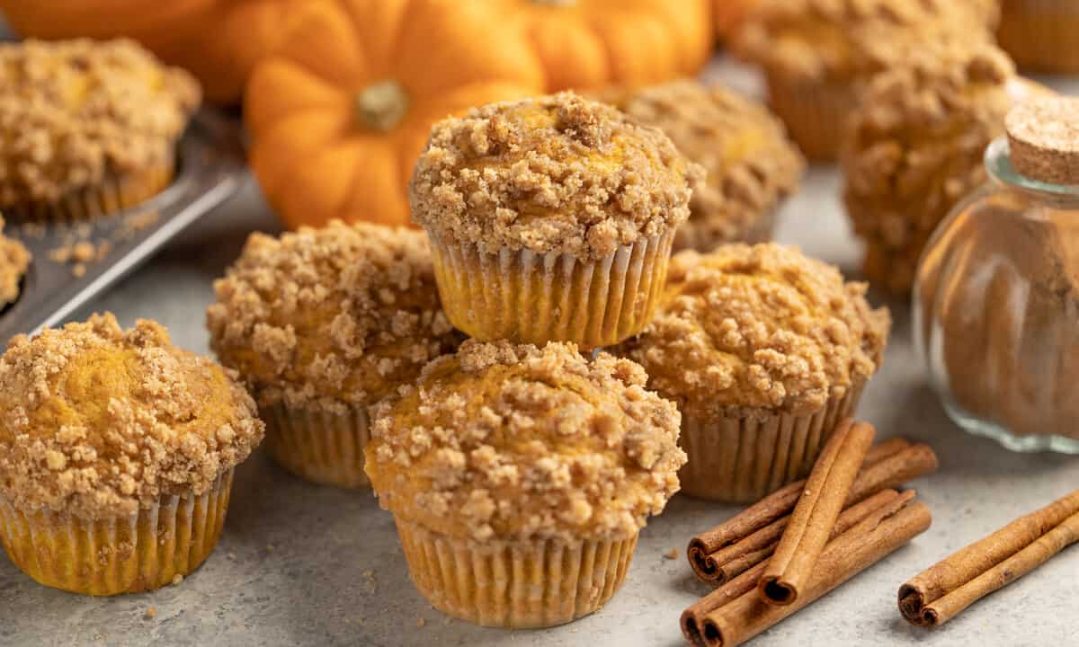 Pumpkin muffins stacked on top of each other.