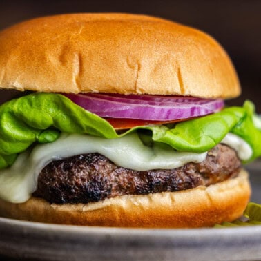 A close up view of Cayt's ranch burger on a gray plate.