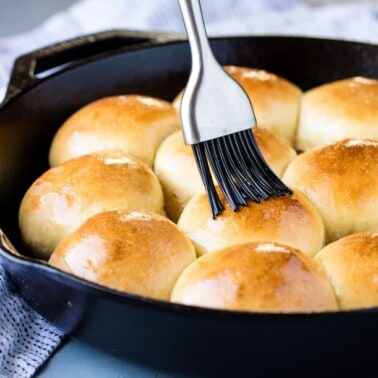 Rapid rise skillet rolls being brushed with butter