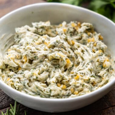 A close up view of a bowl of resting steak butter.