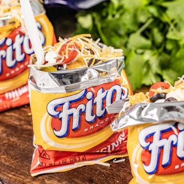 Individual small bags of Fritos full of crispy frito pie.