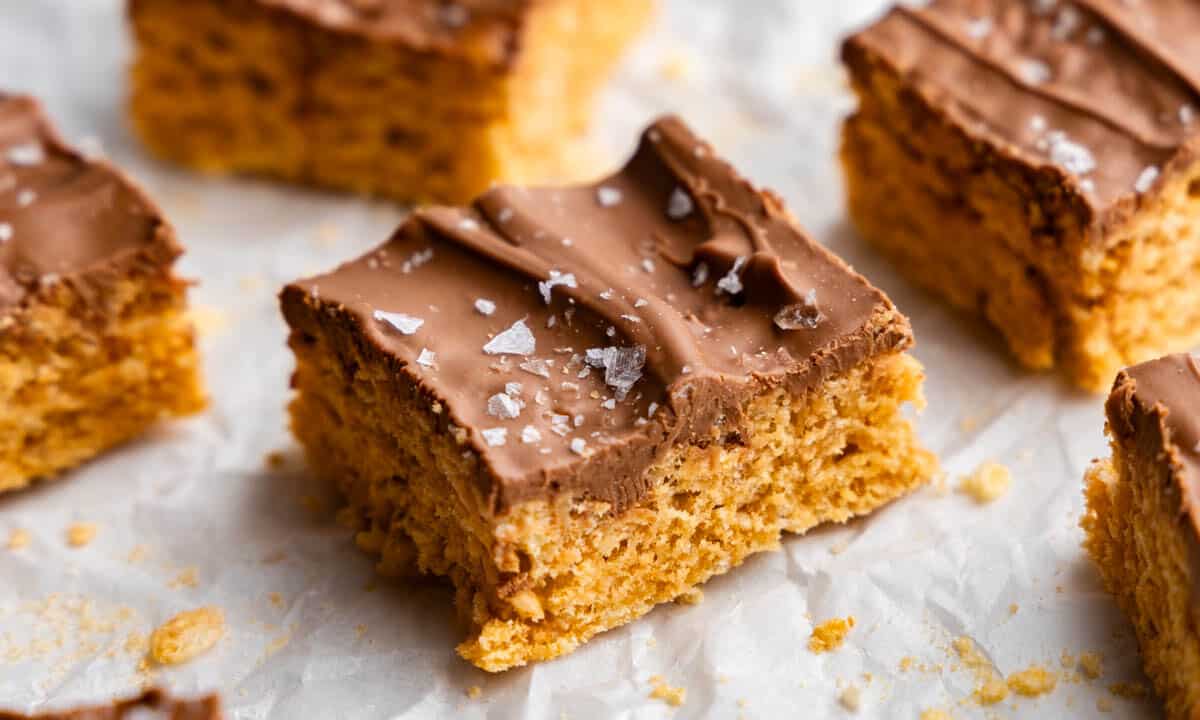 A close up view of a square of homemade scotcharoos, sprinkled in flaked salt.