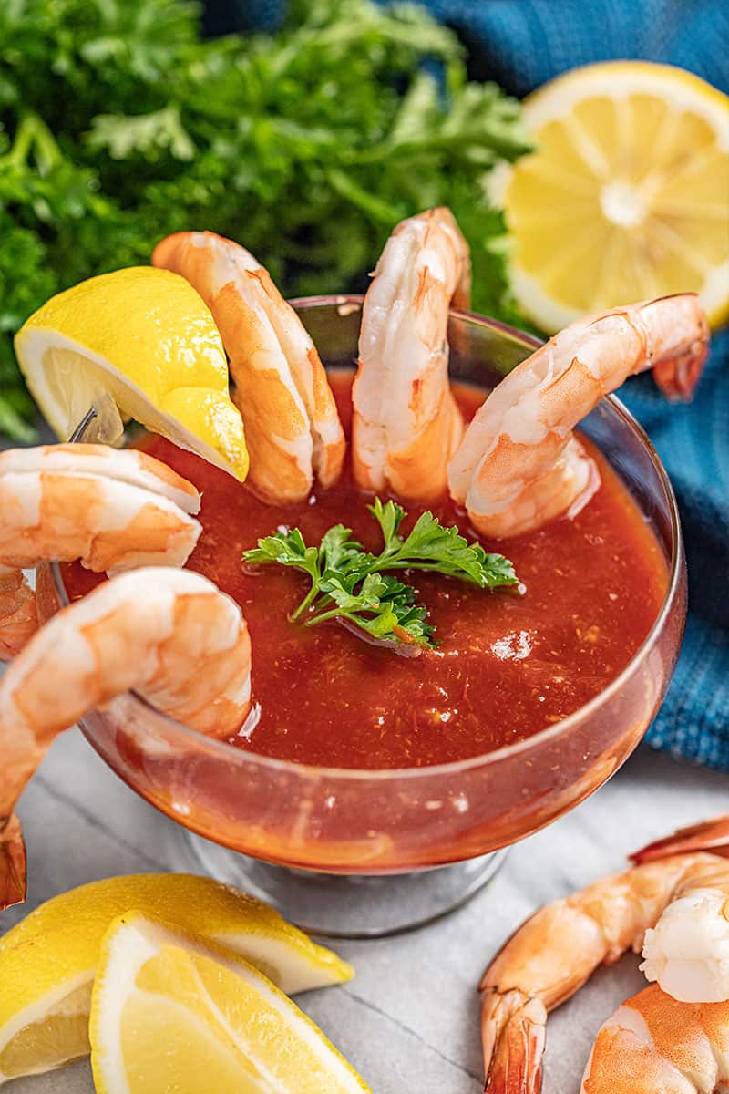 Shrimp Cocktail hanging over a glass.