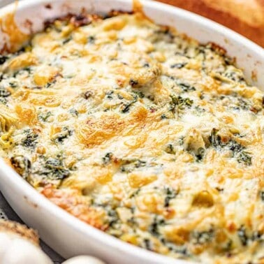 Spinach artichoke dip in white baking dish