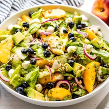 Peach salad in a white bowl.