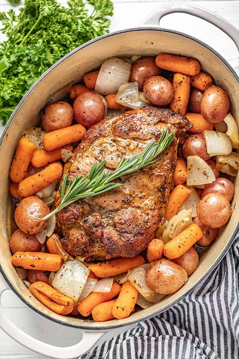 Pork Roast, carrots, baby red potatoes, and onion in a cast iron dutch oven